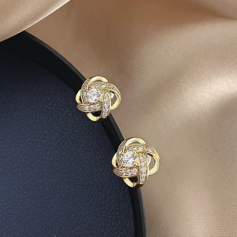 Elara – Boucles d’Oreilles Croix en Fleur Torsadée